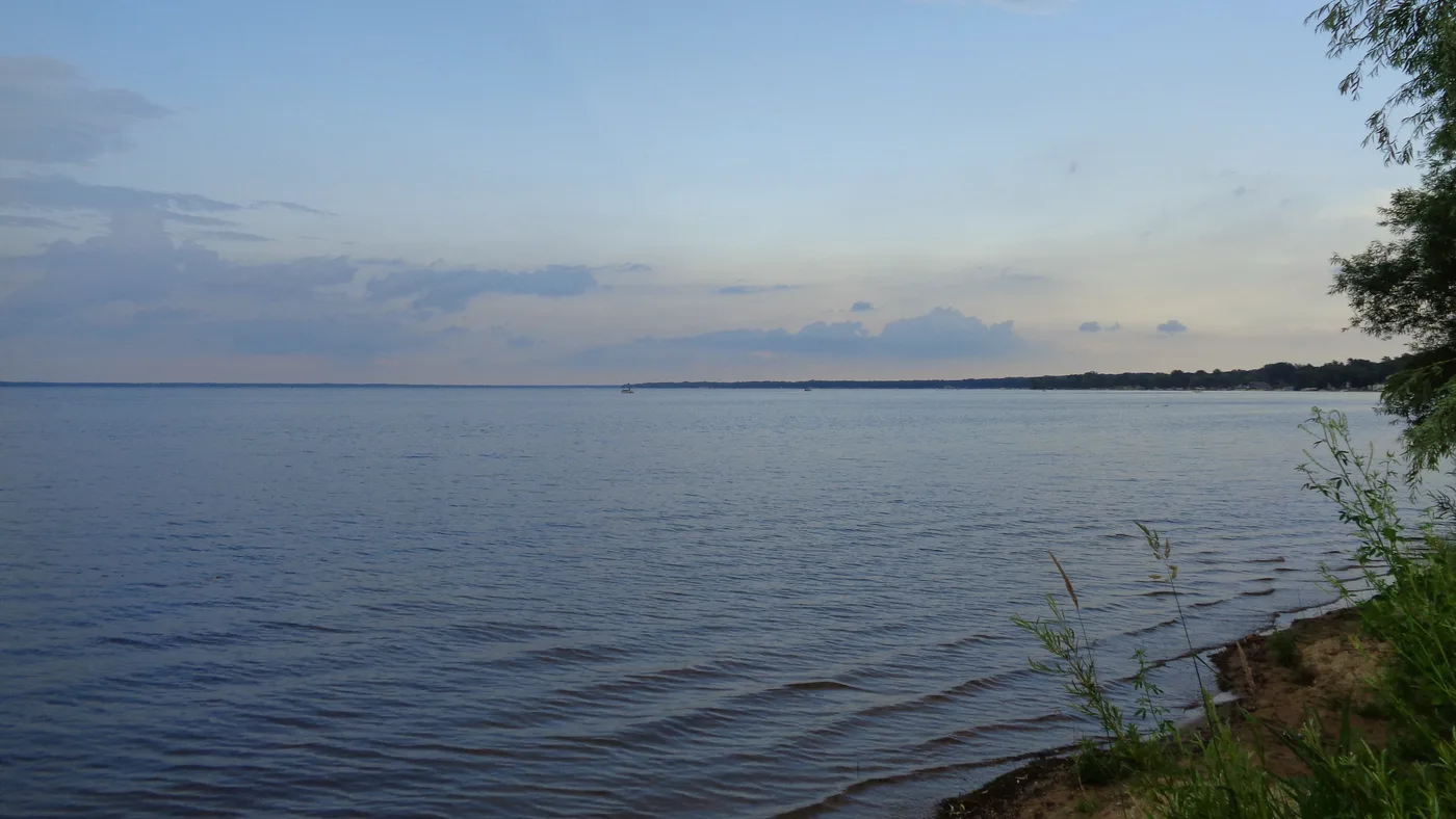 Wide open water of Houghton Lake, Michigan's largest inland lake, stretching to the horizon at dusk