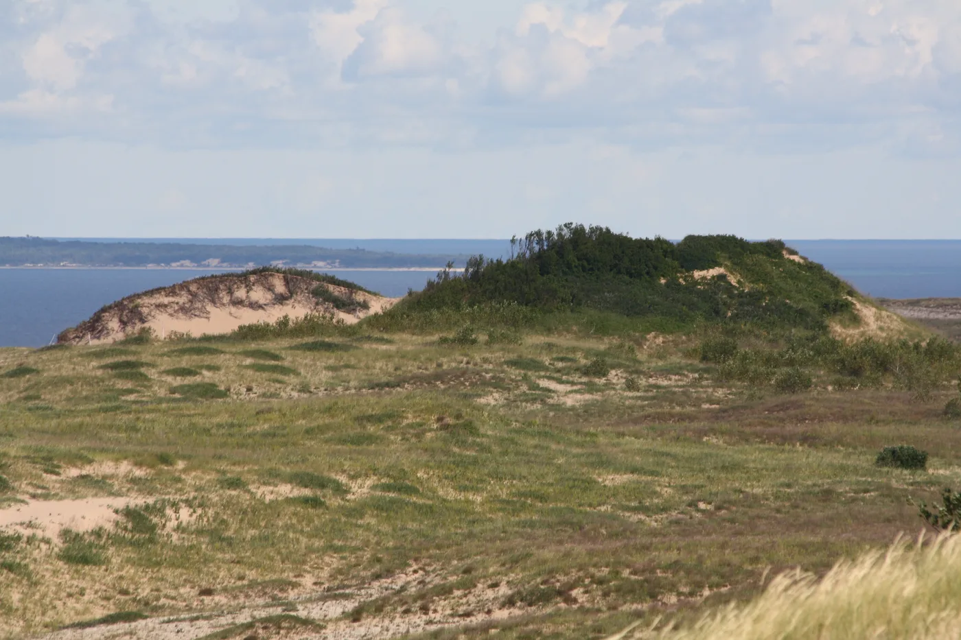 Sand and dune-grass ridges of Sleeping Bear Dunes rising above Lake Michigan near Glen Arbor